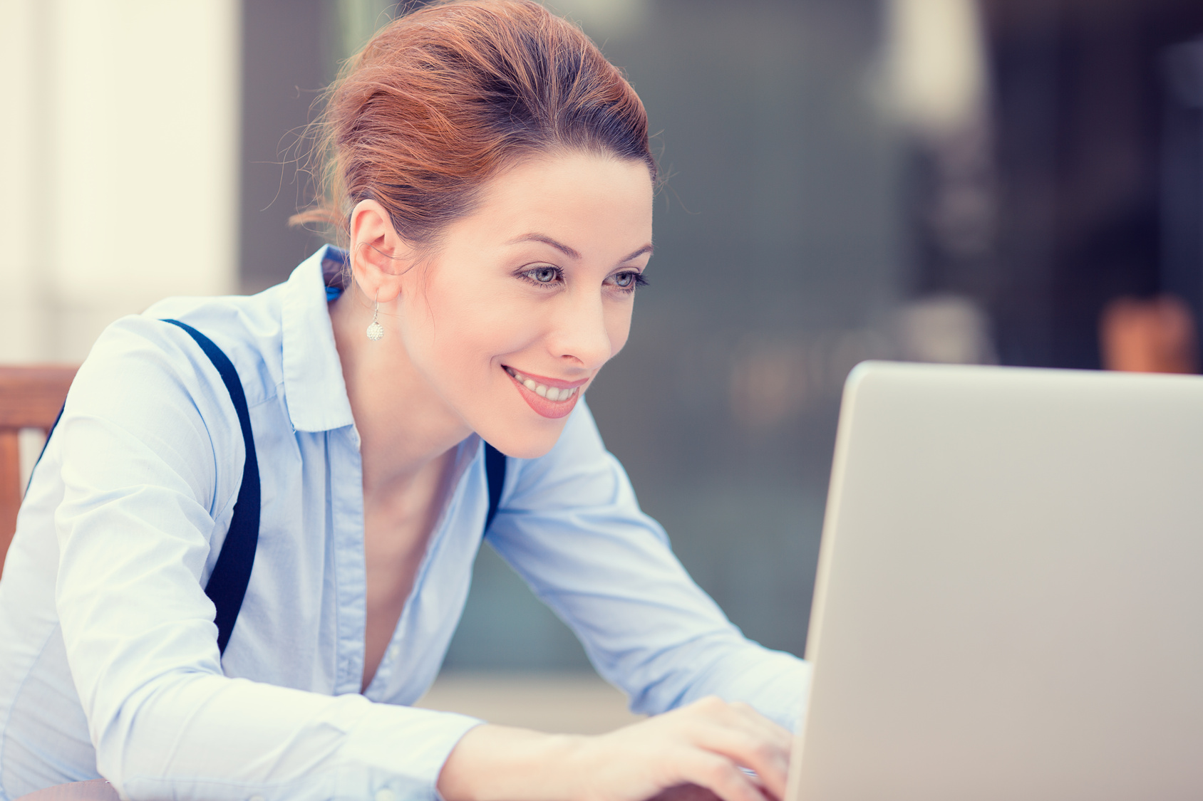 Happy woman working on computer laptop browsing internet