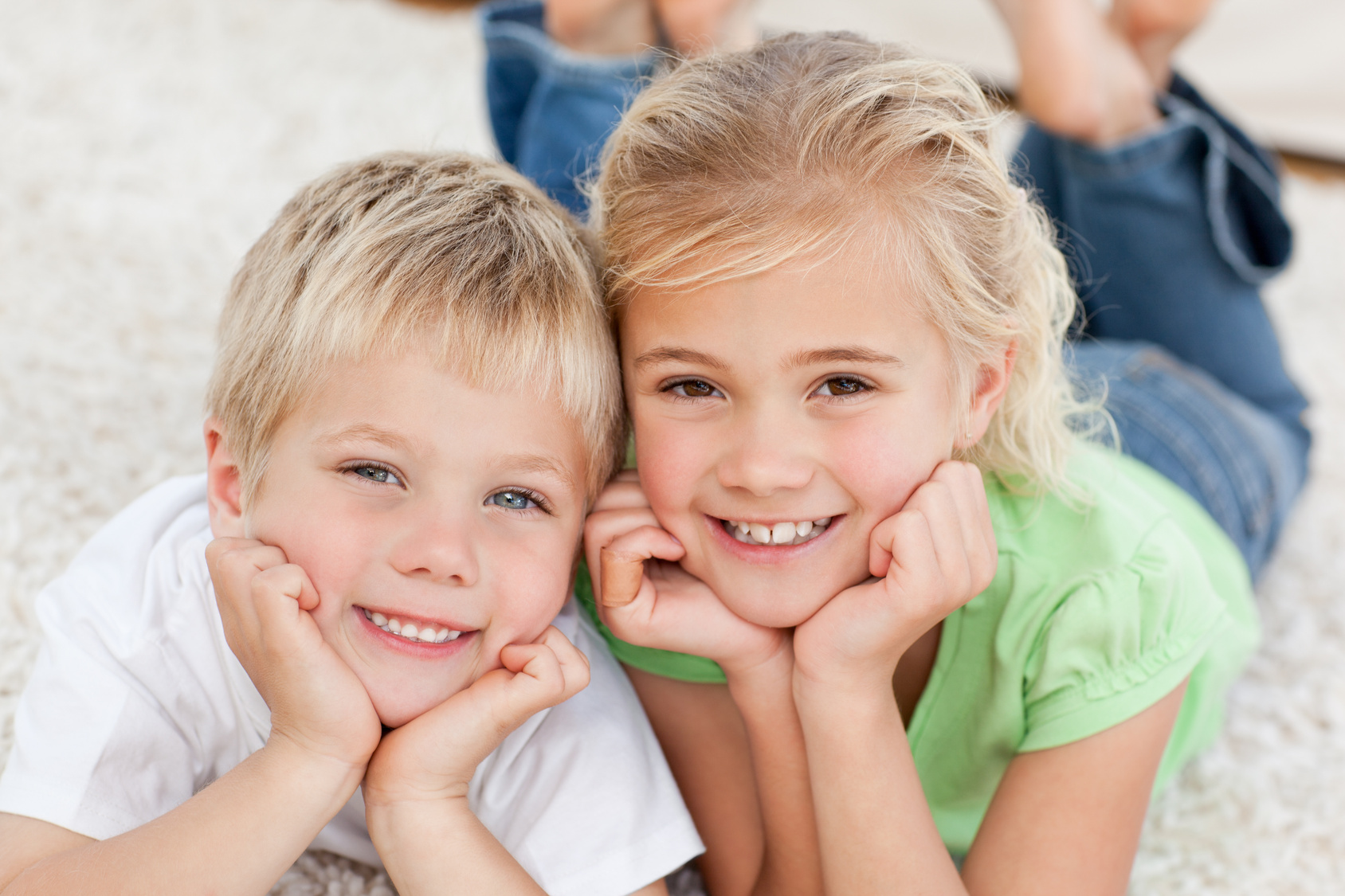 Sister and Son smilling to the camera in the carpet