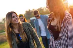 Portrait of group of friends having fun in field.