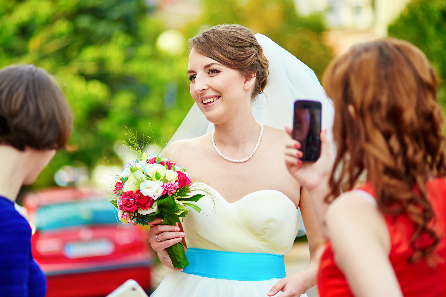 Bridesmaid is taking photo of a bride