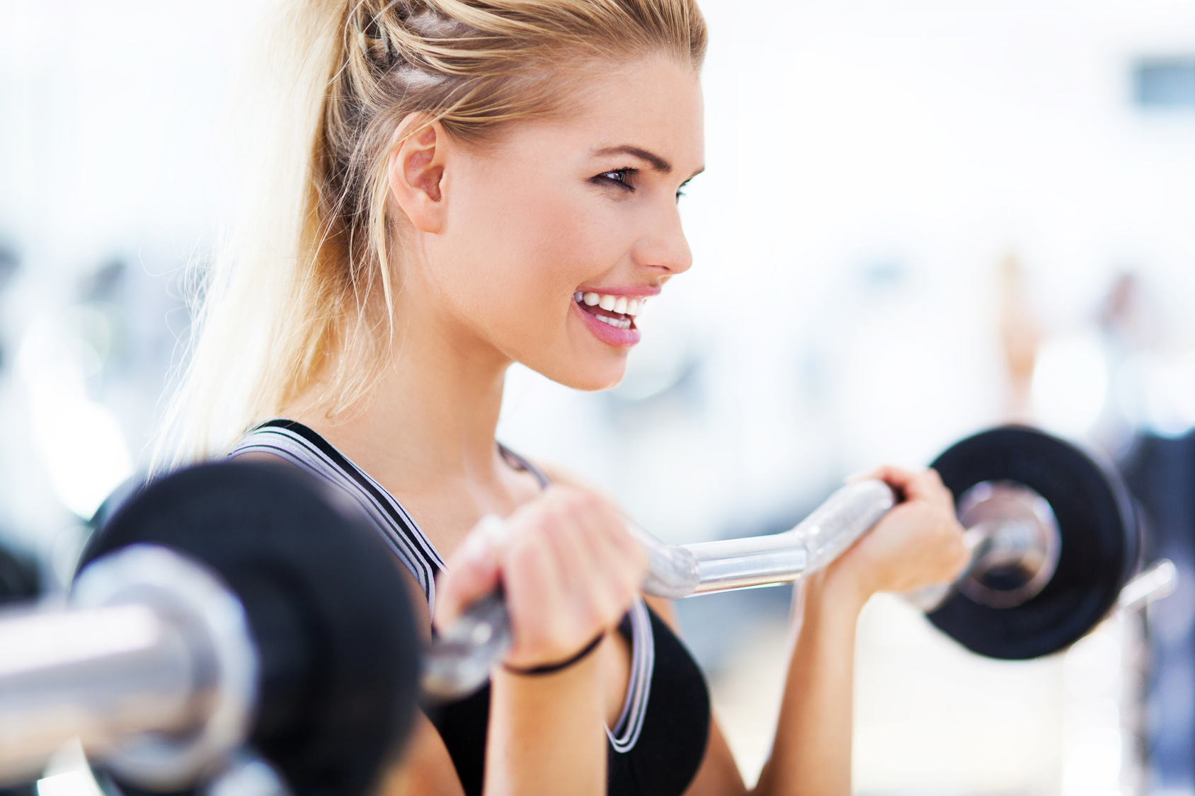 Woman in gym lifting weights