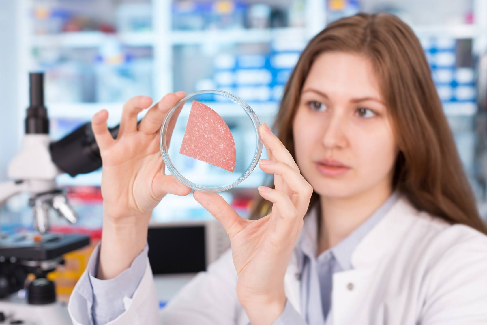 girl in the laboratory of food quality tests sausage