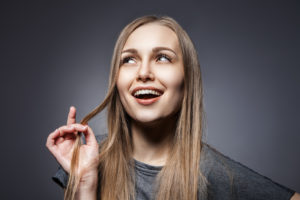 Attractive woman looking up over dark grey