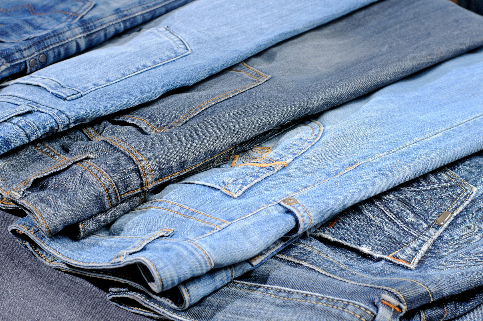 Colored jeans arranged in one row