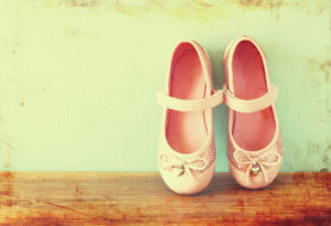 girl shoes over wooden deck floor