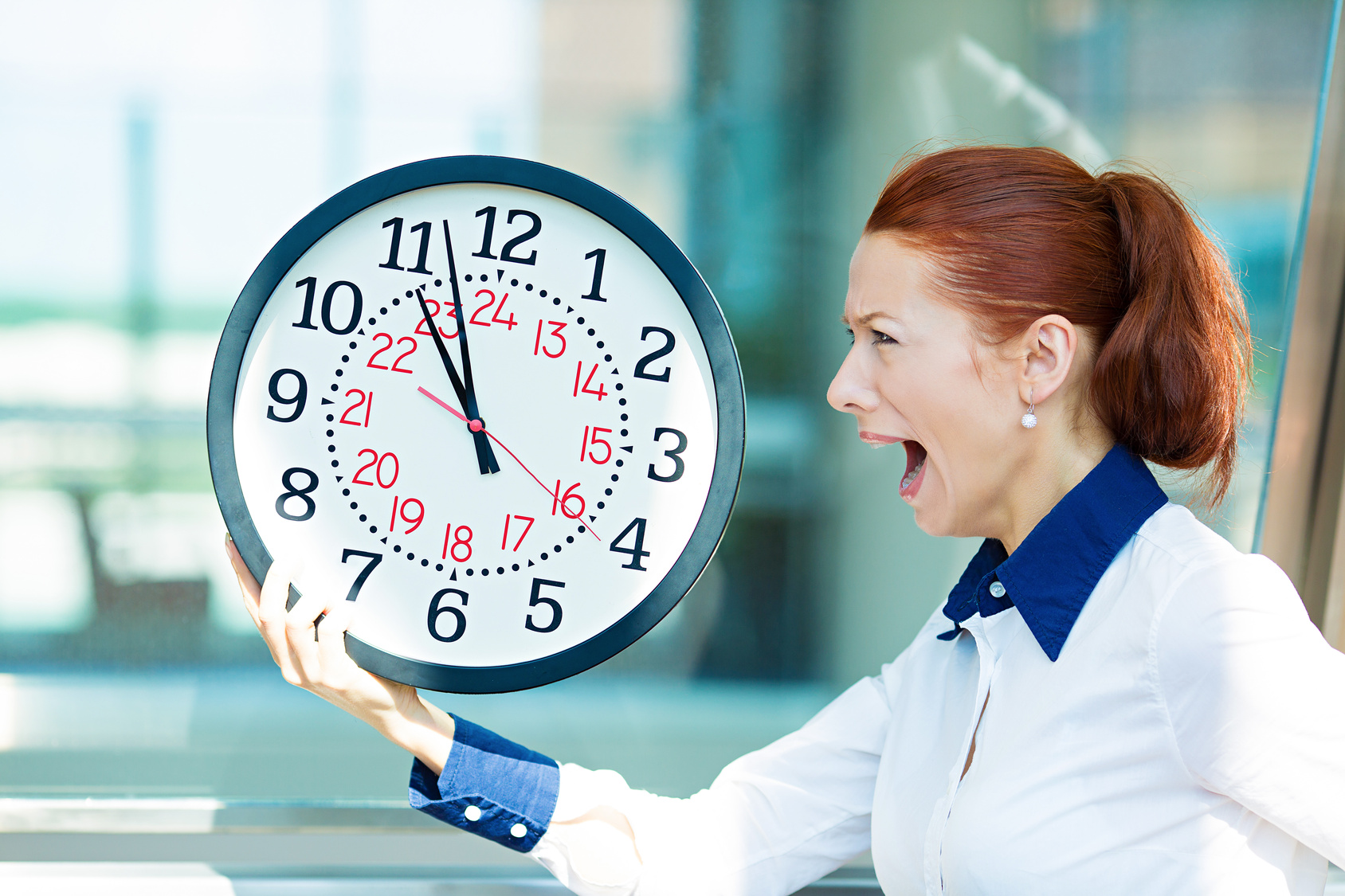 Business woman running out of time corporate office background