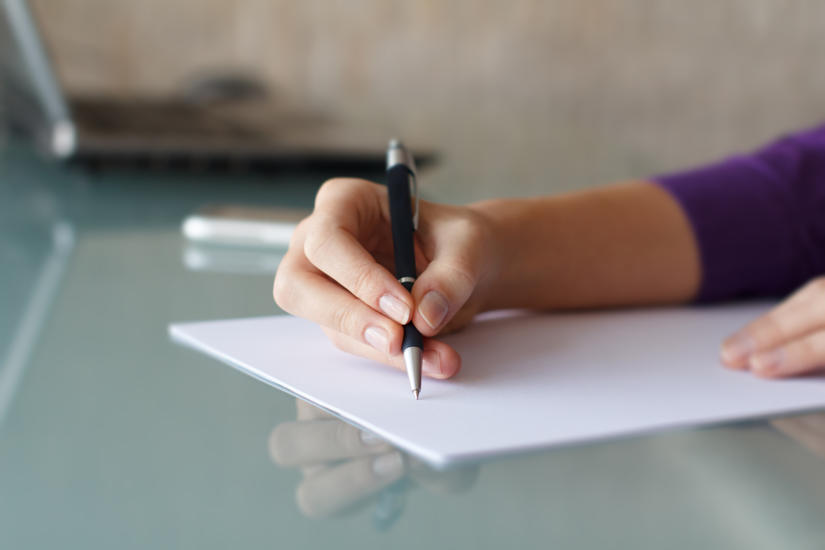 Businesswoman writing with pen