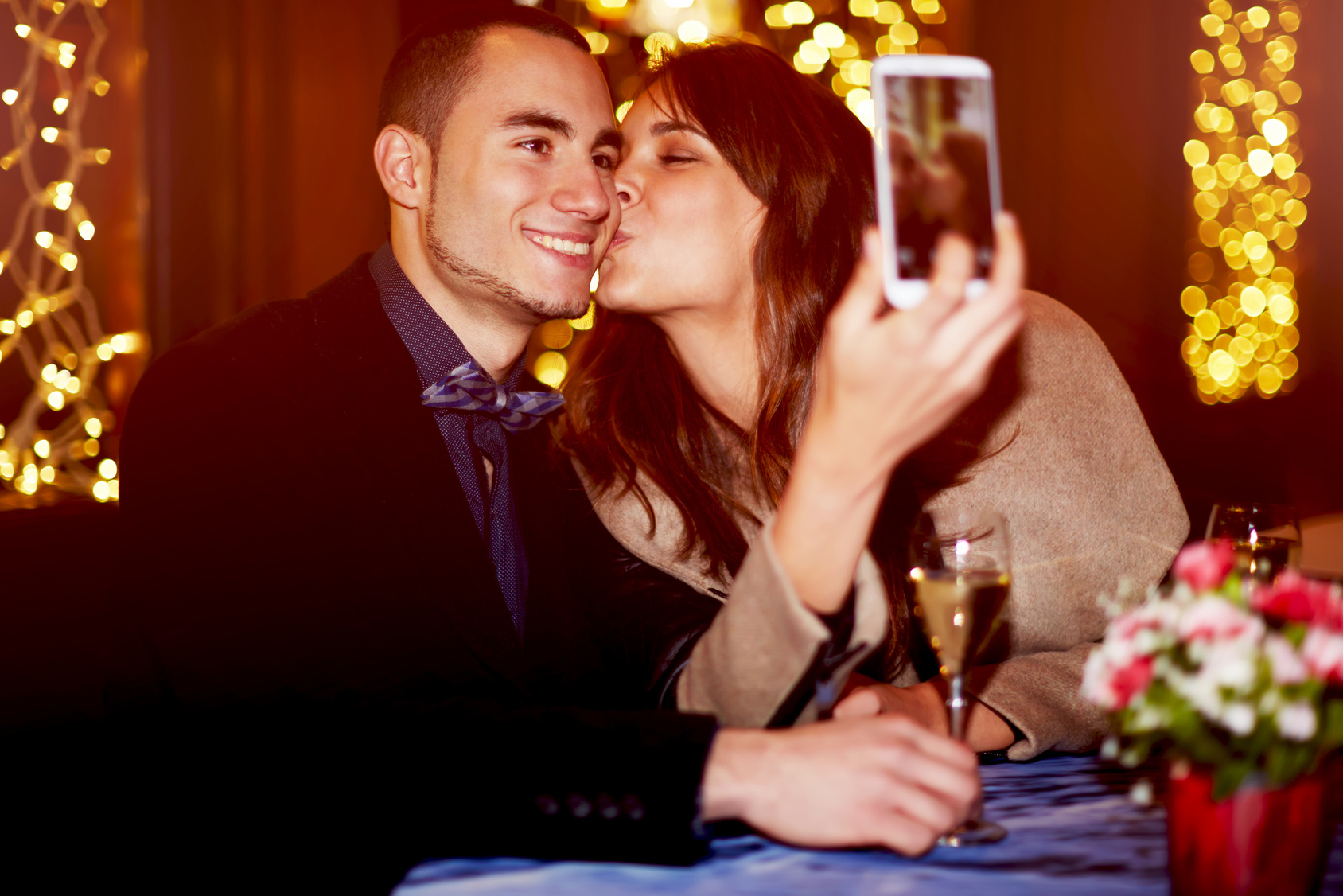 Happy romantic couple making selfie photo with smartphone