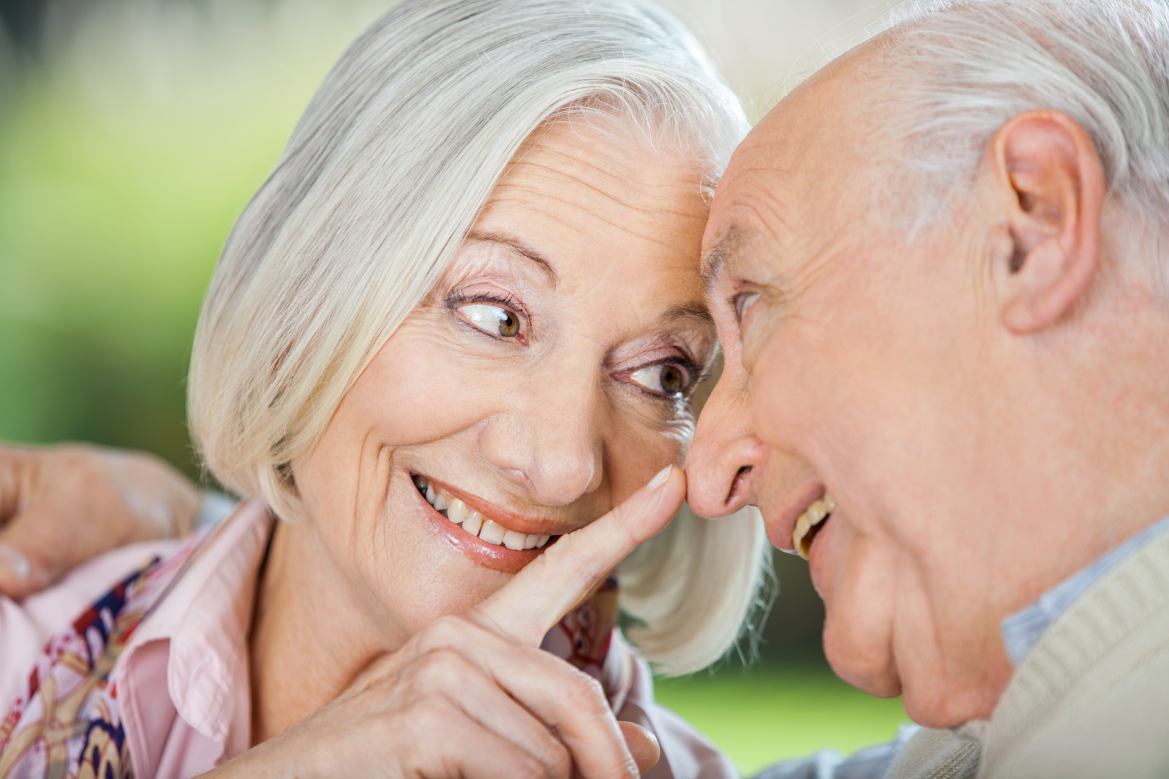 Loving Senior Woman Touching Man’s Nose