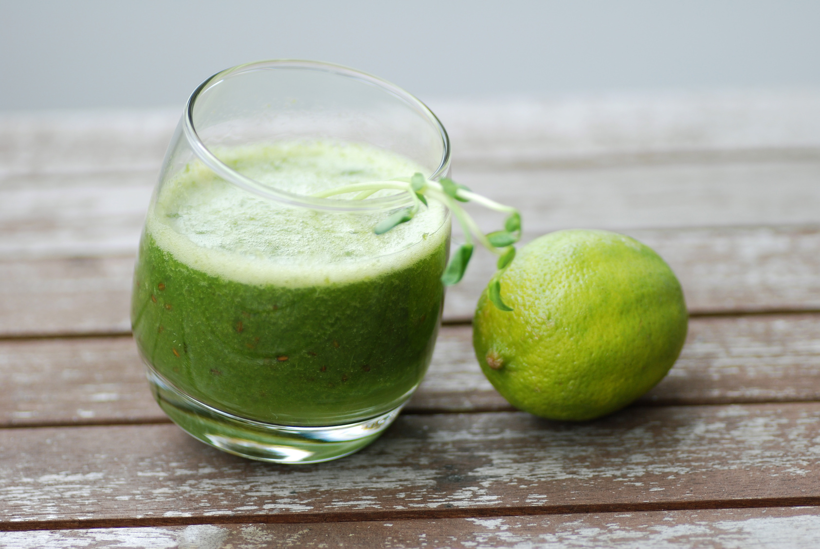 green smoothie on table with lime