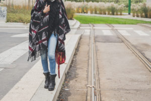 Detail of a young woman posing in the city streets
