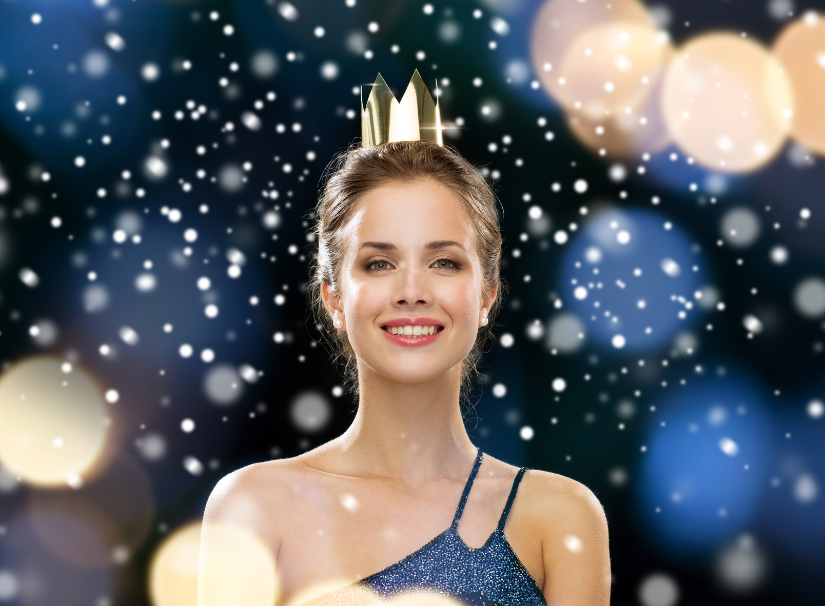 smiling woman in evening dress wearing crown