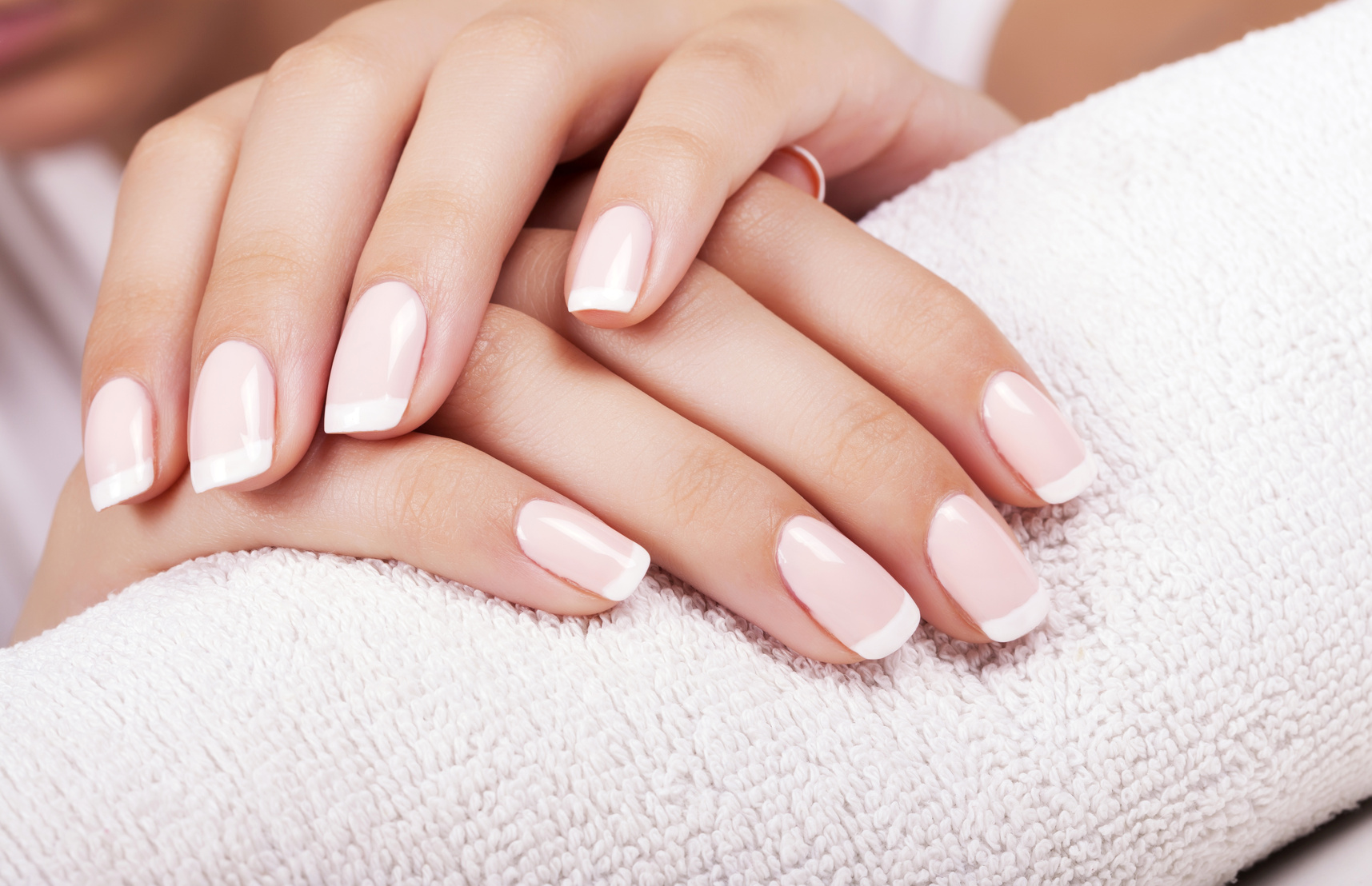 Beautiful woman’s nails with french manicure.