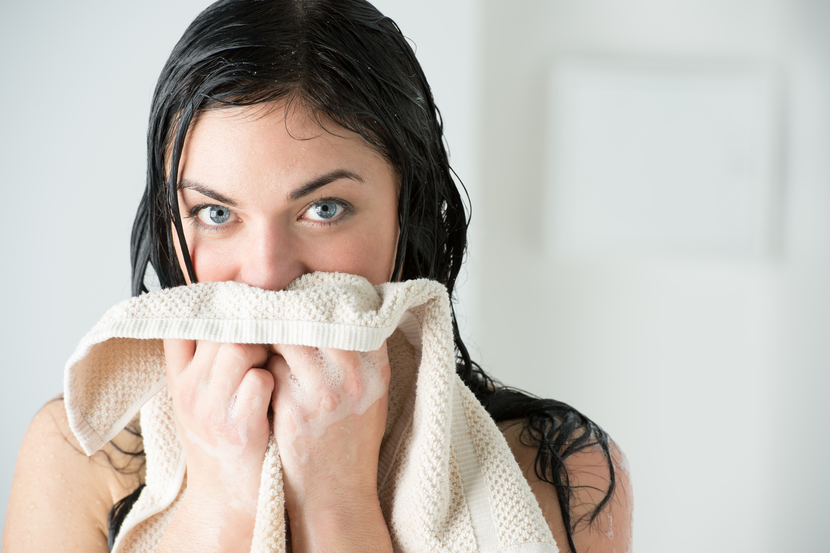 Sexy woman wiping herself with towel after taking shower