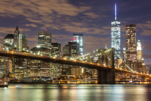 Brooklyn Bridge and Downtown Skyscrapers in New York at Dusk