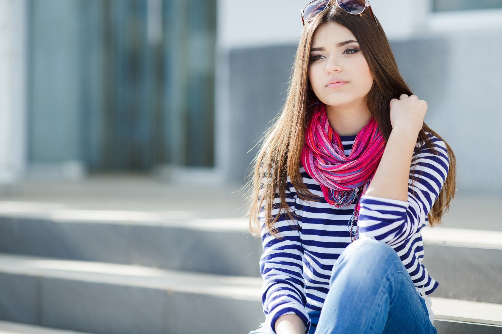 Portrait of a beautiful young woman sitting on the steps.