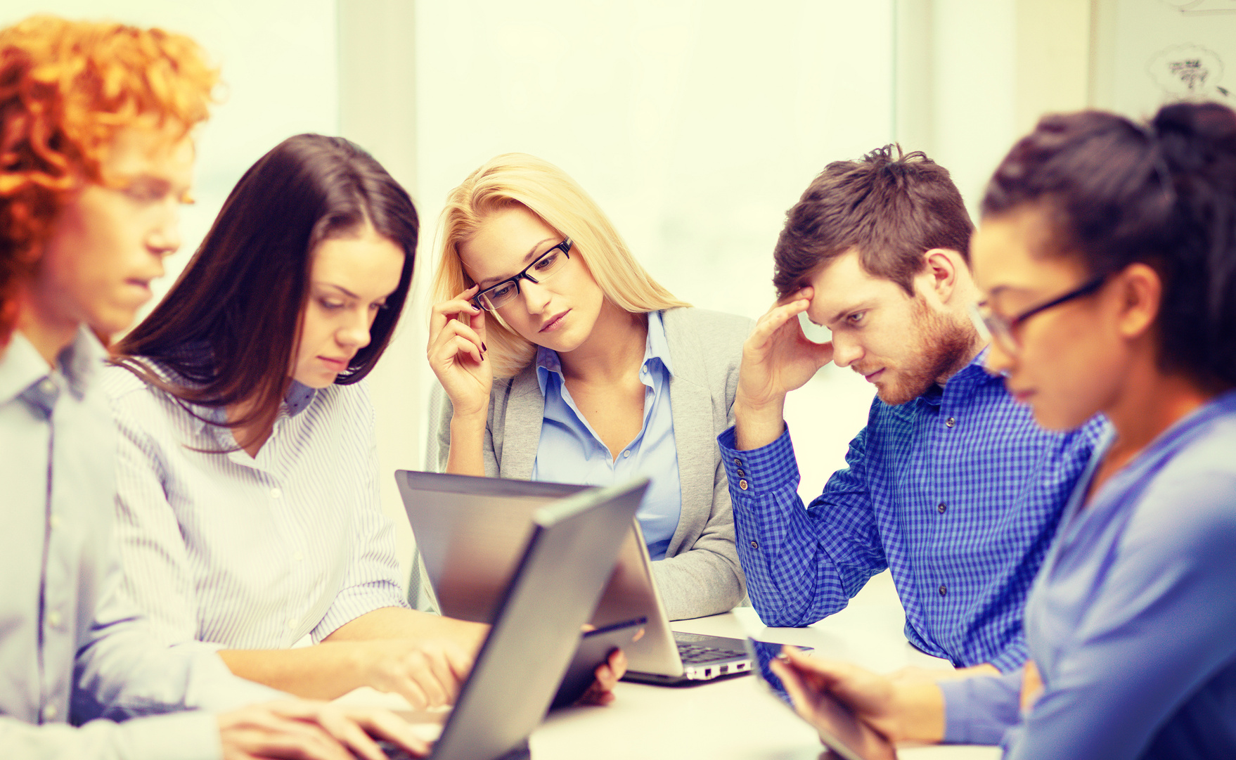 depressed team with laptop and table pc computers