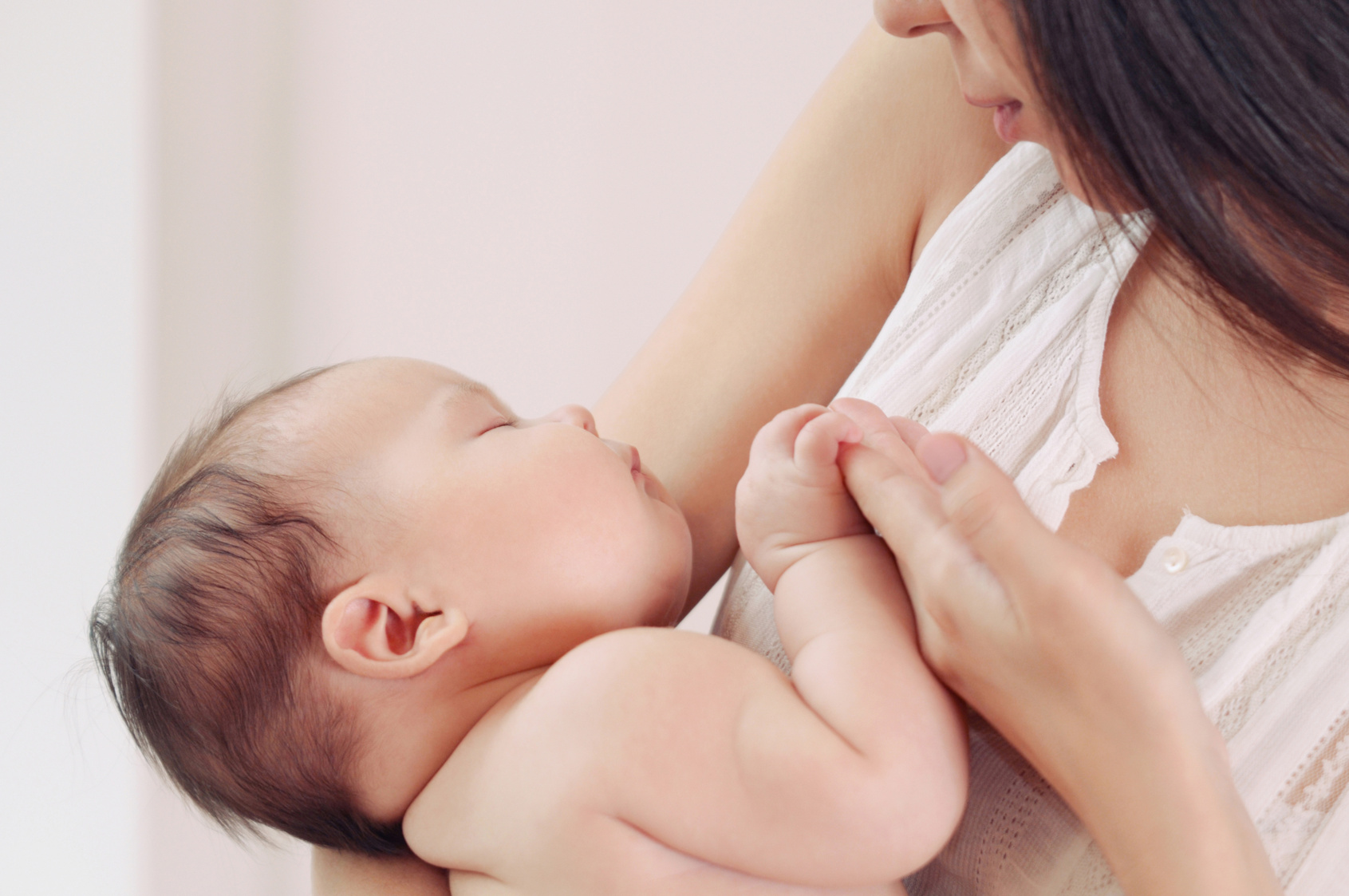 soft image of mother and her newborn baby