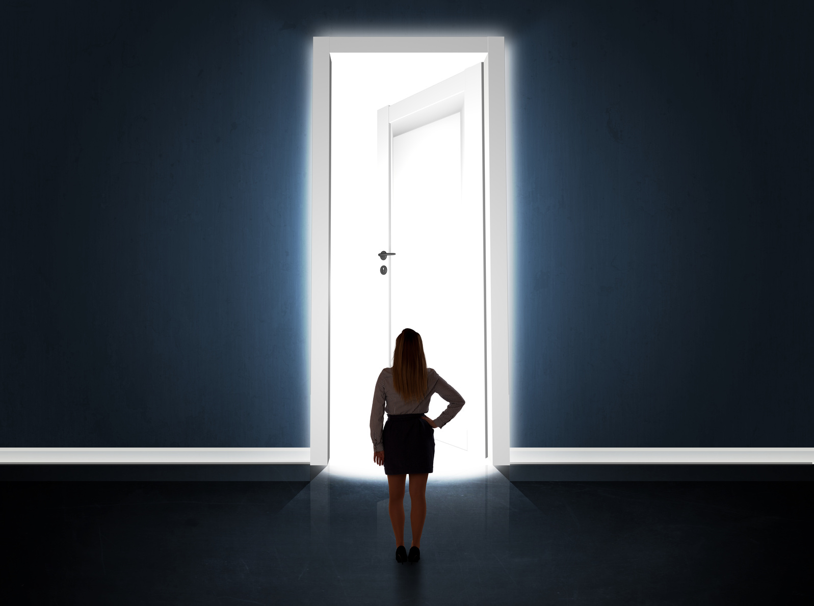 Business woman looking at big bright opened door
