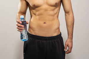 Closeup of man holding bottle of water