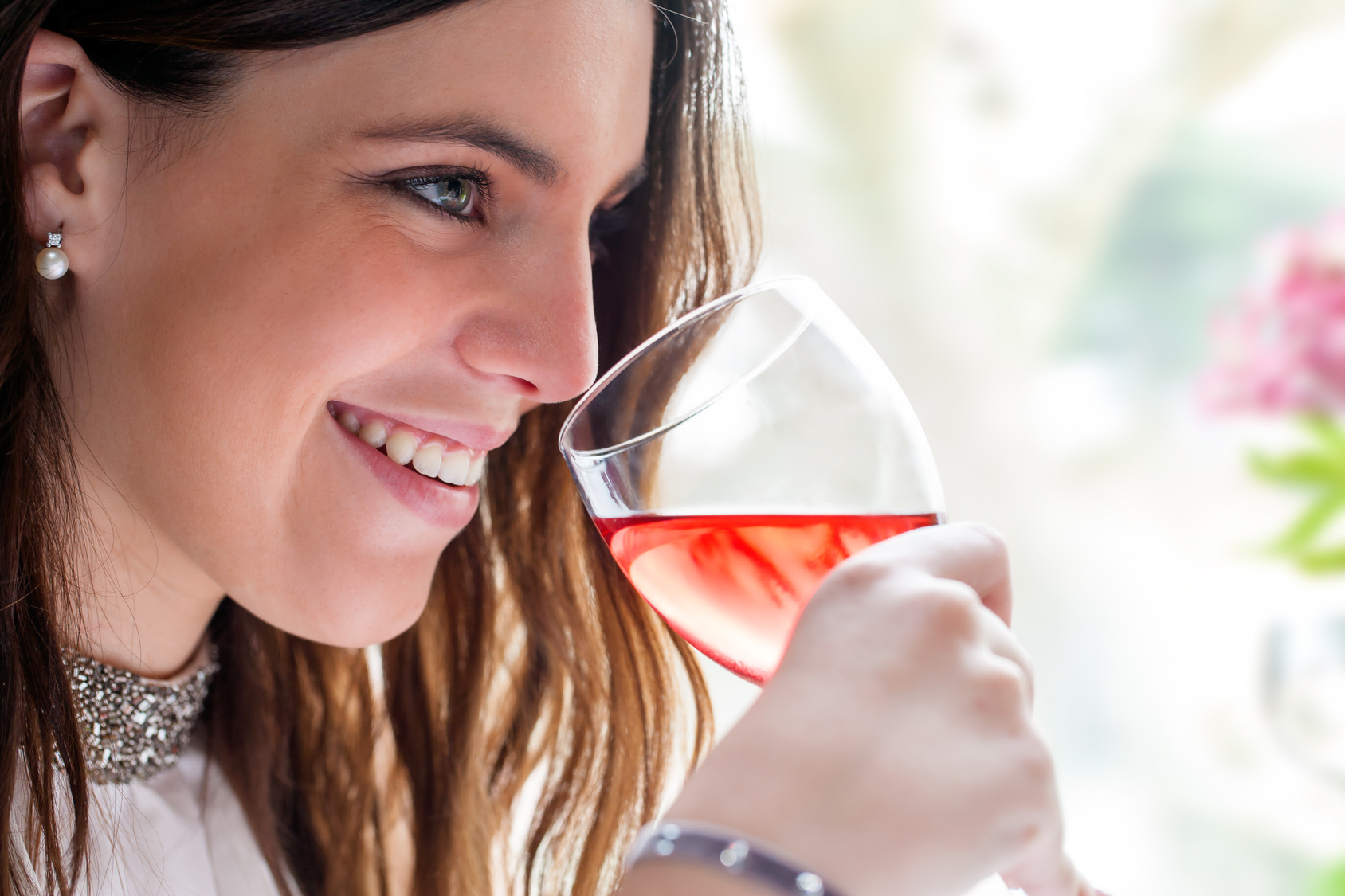 Attractive girl enjoying glass of wine.