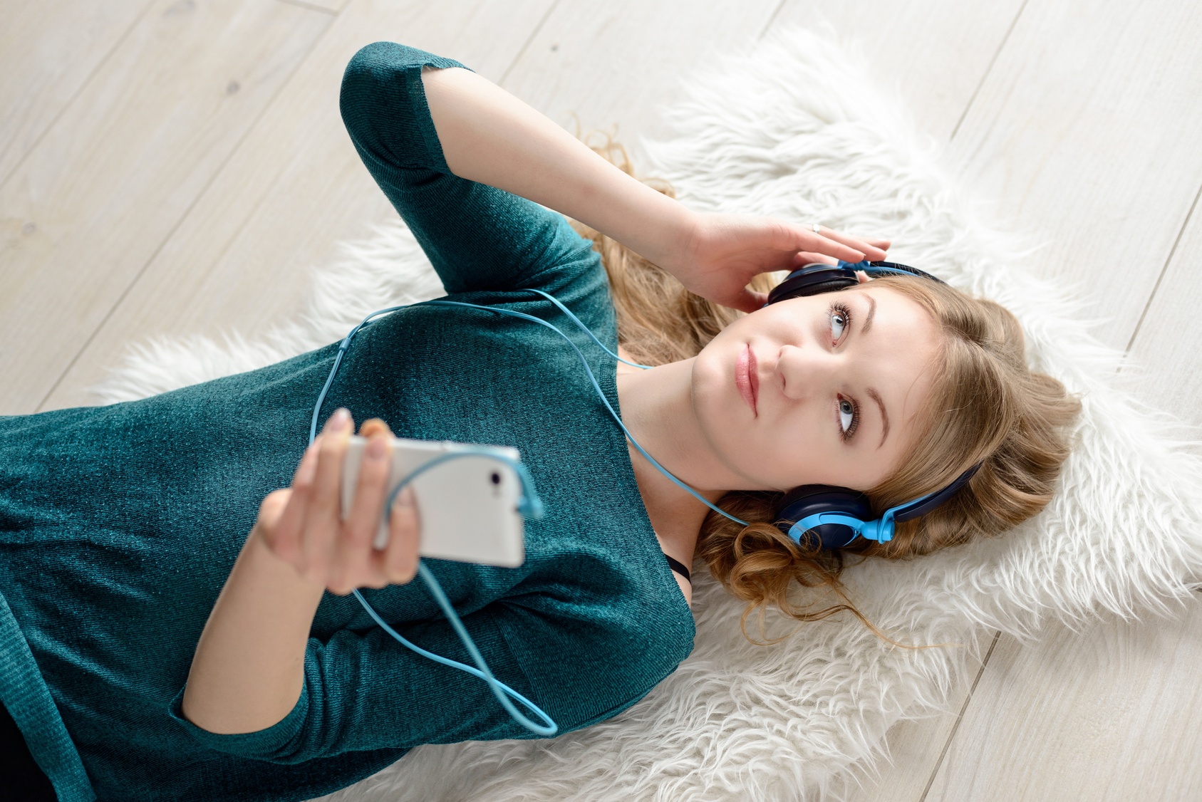 Beautiful young blond woman listening to music