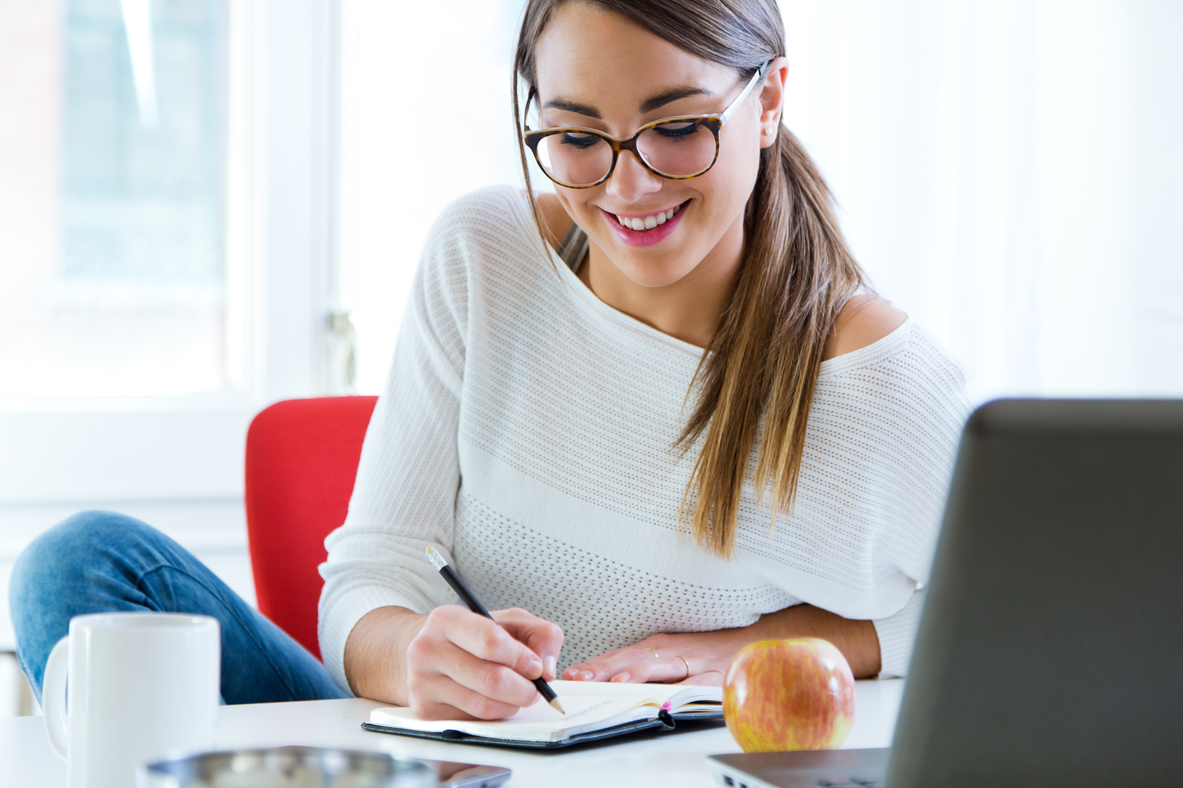 Pretty young woman working in her office.