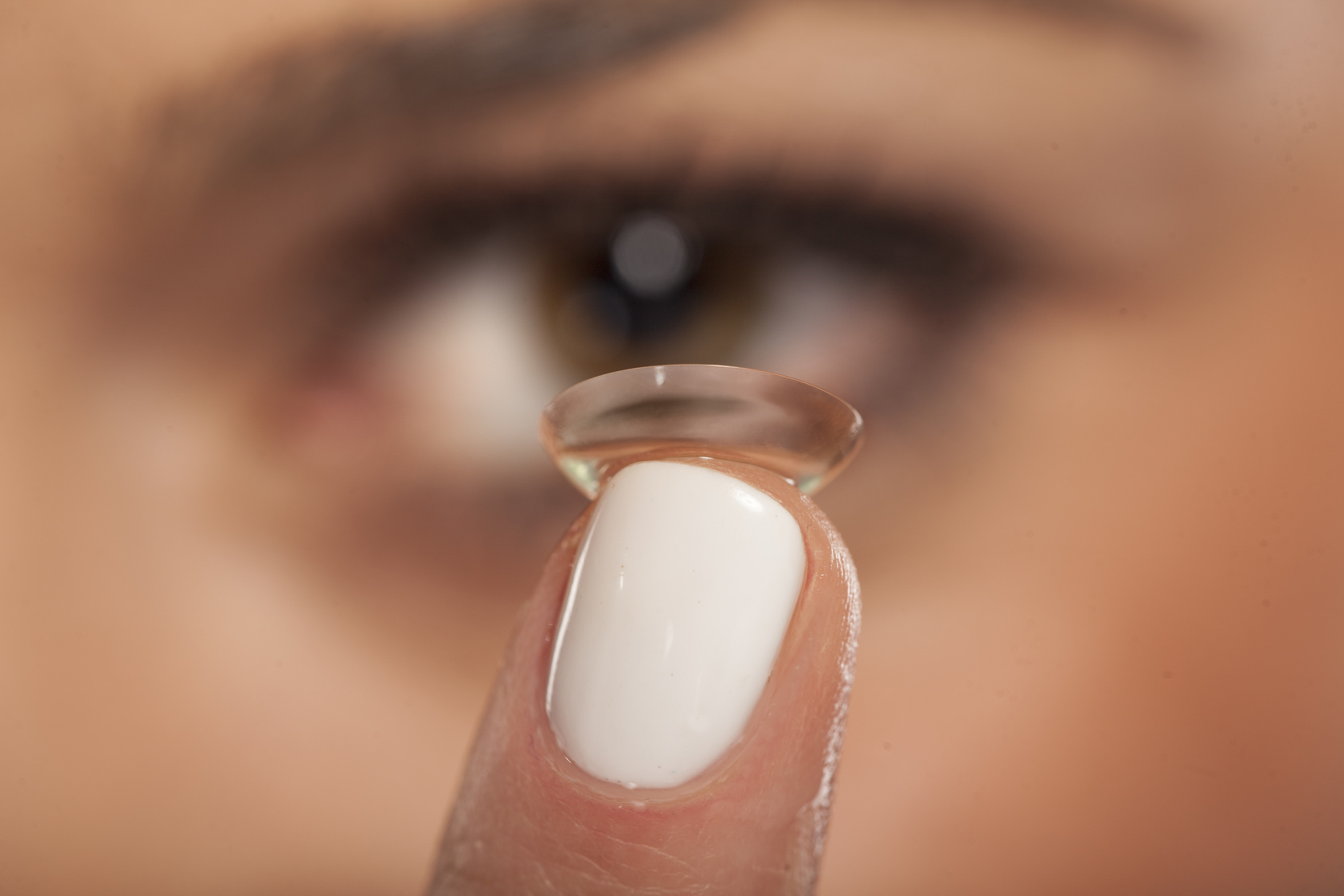 Close up of a girl inserting contact lens