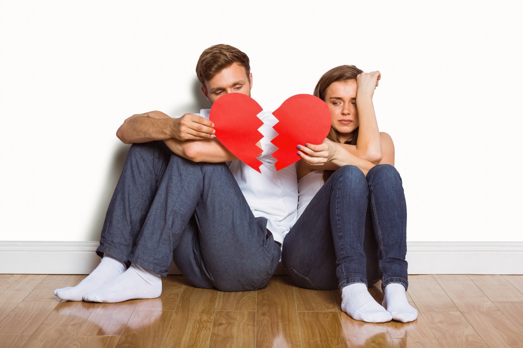 Young couple holding broken heart