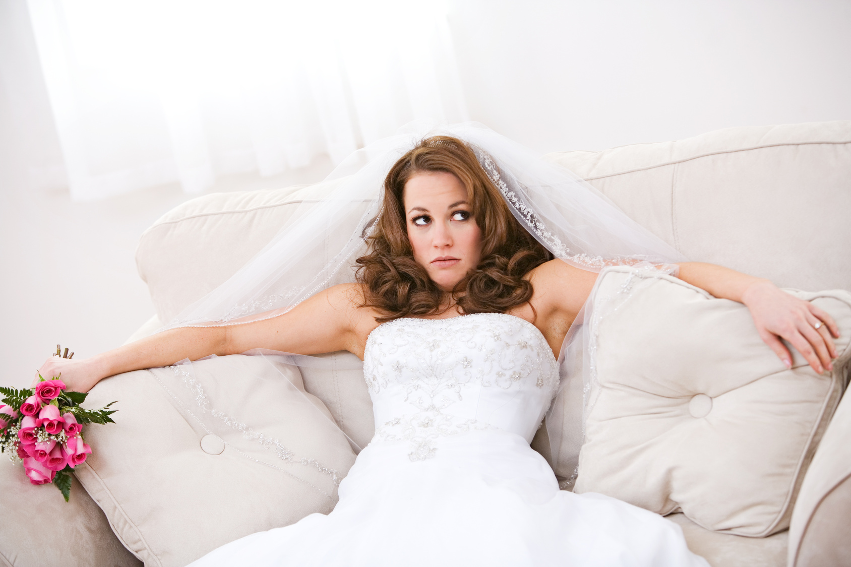 Bride: Annoyed Bride Sits On Couch with Bouquet