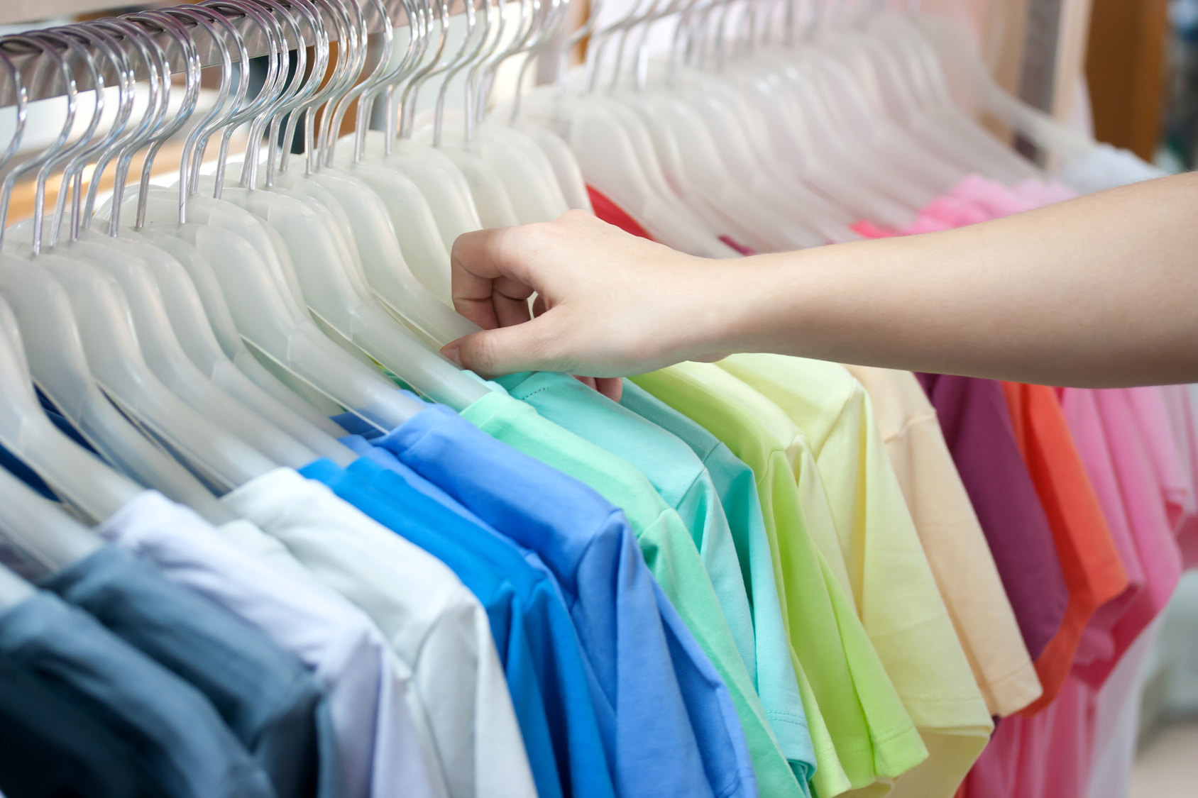 Colorful t-shirt on hangers