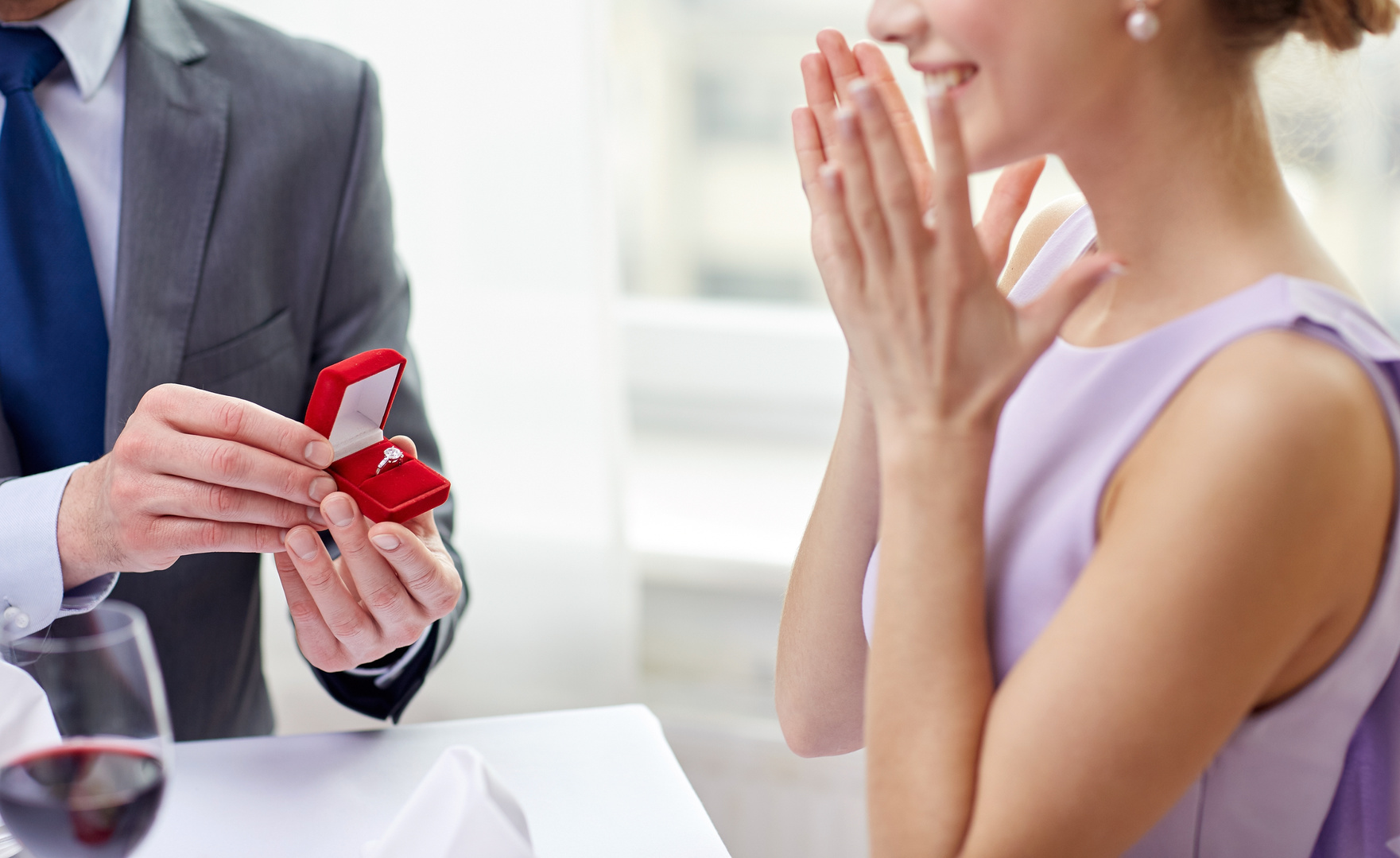 excited young woman and boyfriend giving her ring