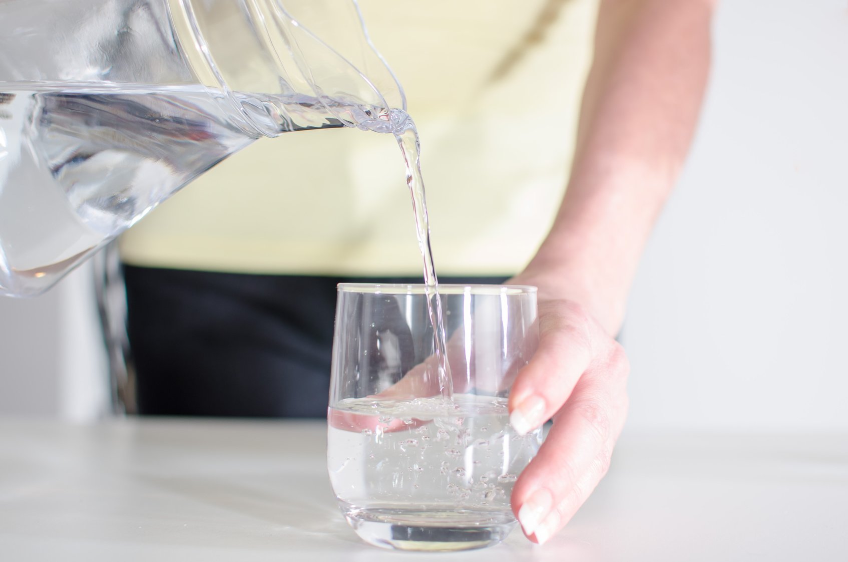 Woman pouring water into a glass