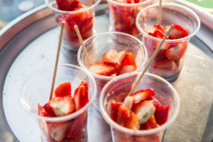 strawberry in plastic cups at street market