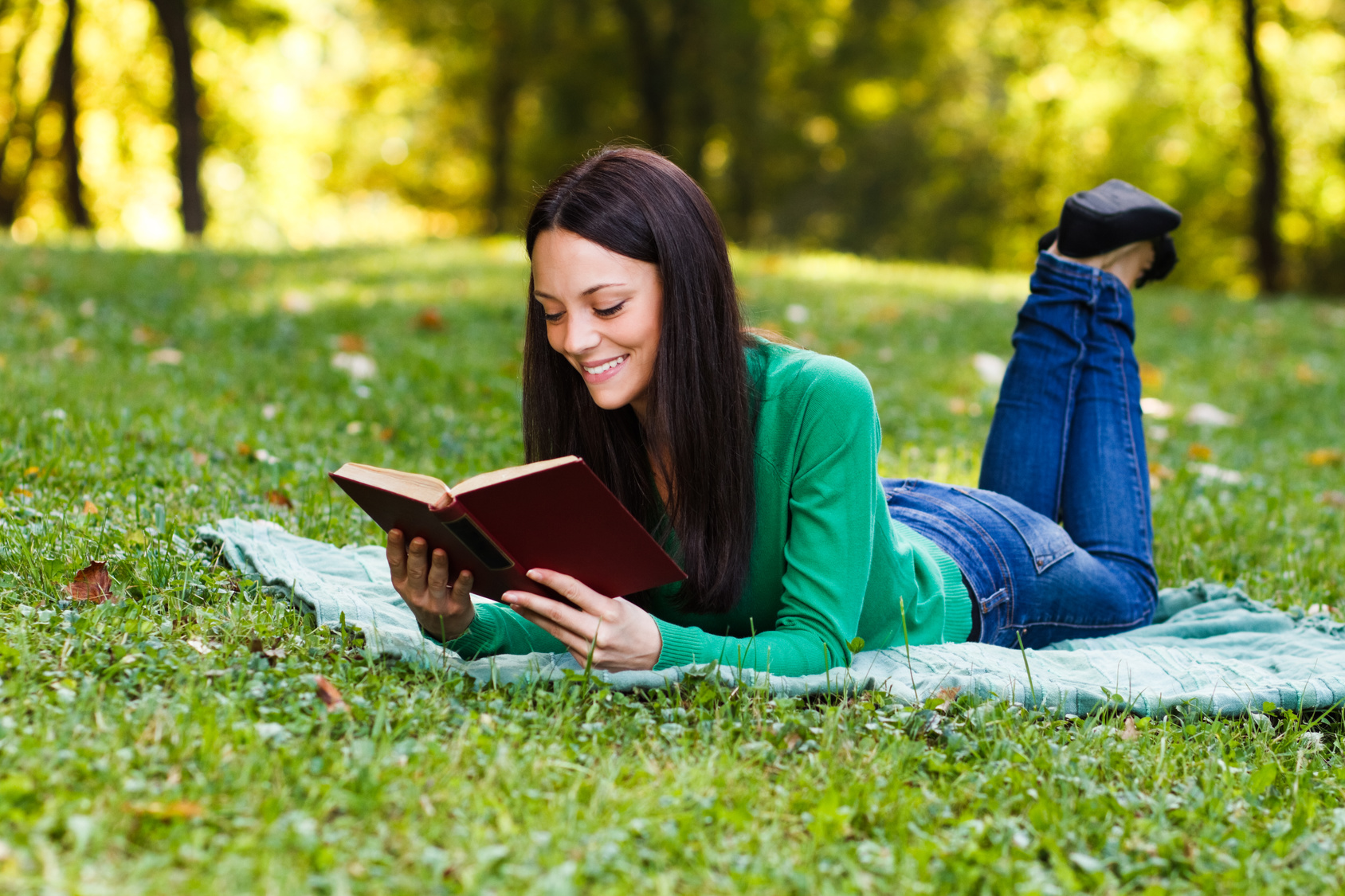 Woman reading book in park