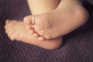 Small delicate little feet of newborn