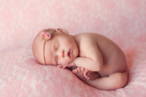 Sleeping Newborn Baby Girl on Pink