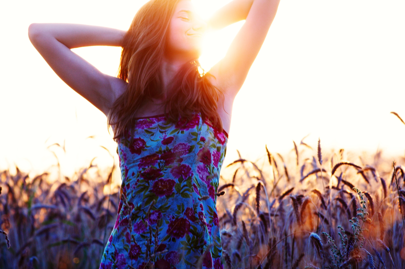 Young woman portrait in straw field