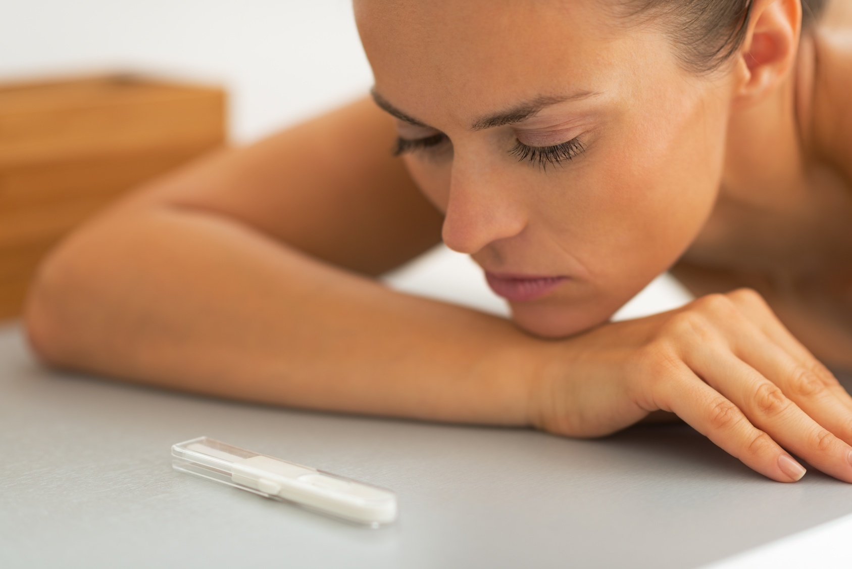 Portrait of young woman looking on pregnancy test