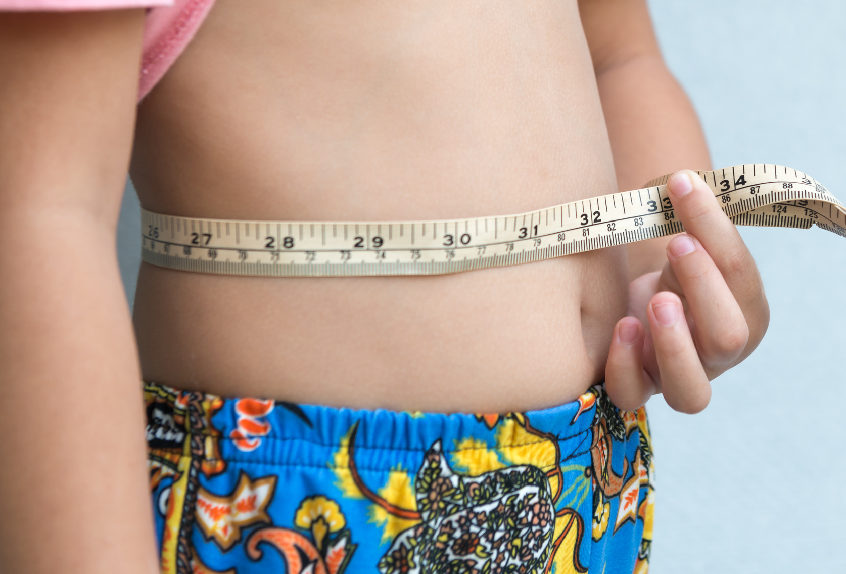 Little girl measuring her stomach