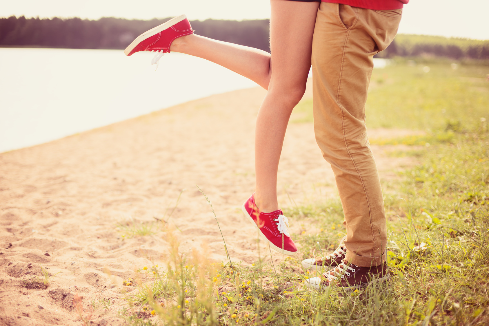 romantic couple kissing on a hot summer beach