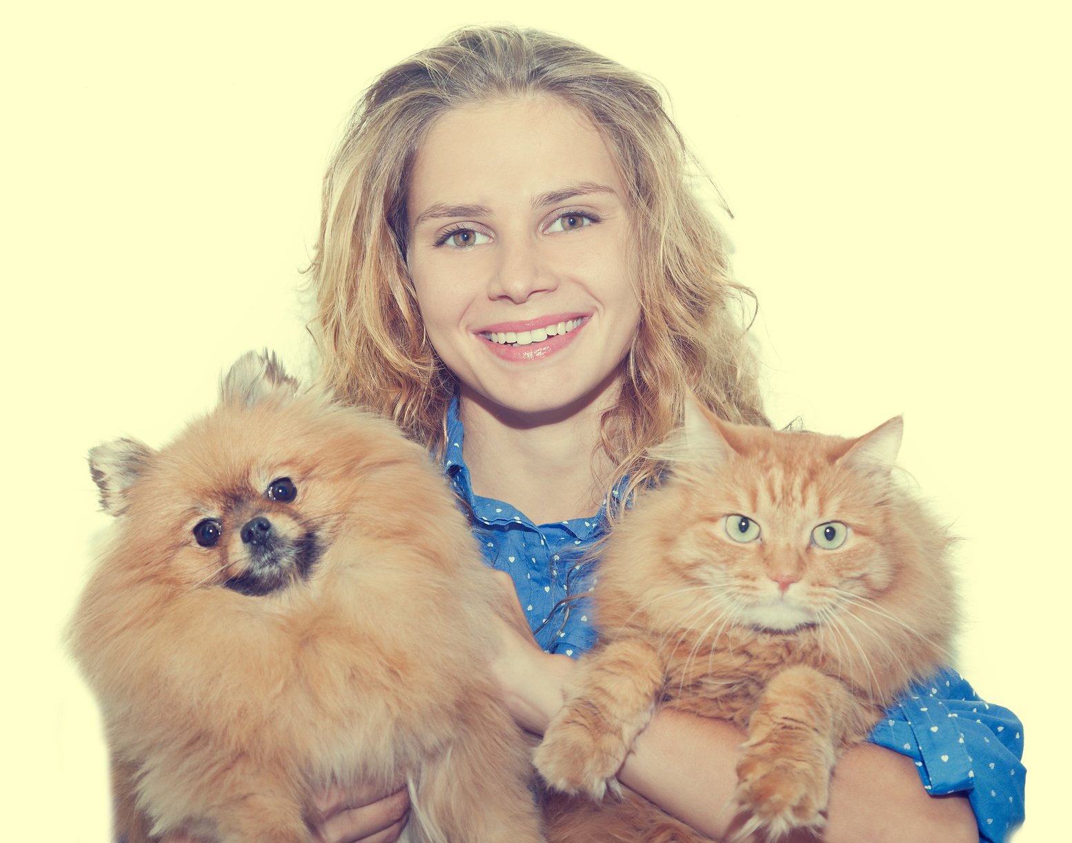 young woman with Pomeranian and red cat