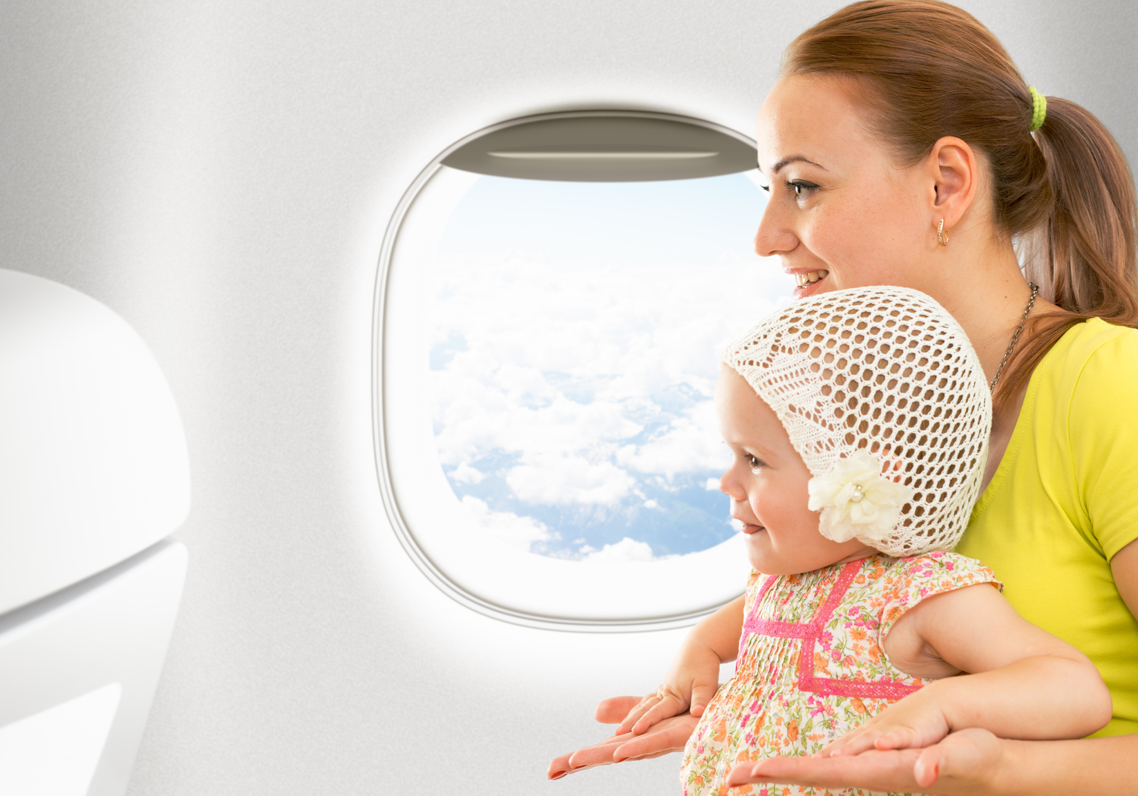 Airplane flight from inside. Woman and kid travelling together.