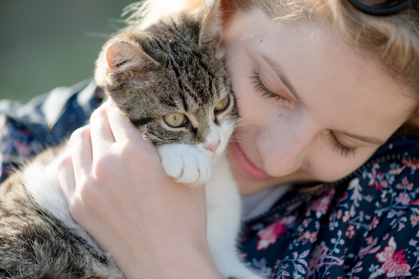 Blonde woman playing with her adorable cat