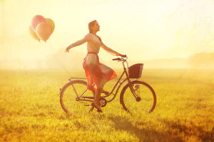 Woman on a Bike with balloons