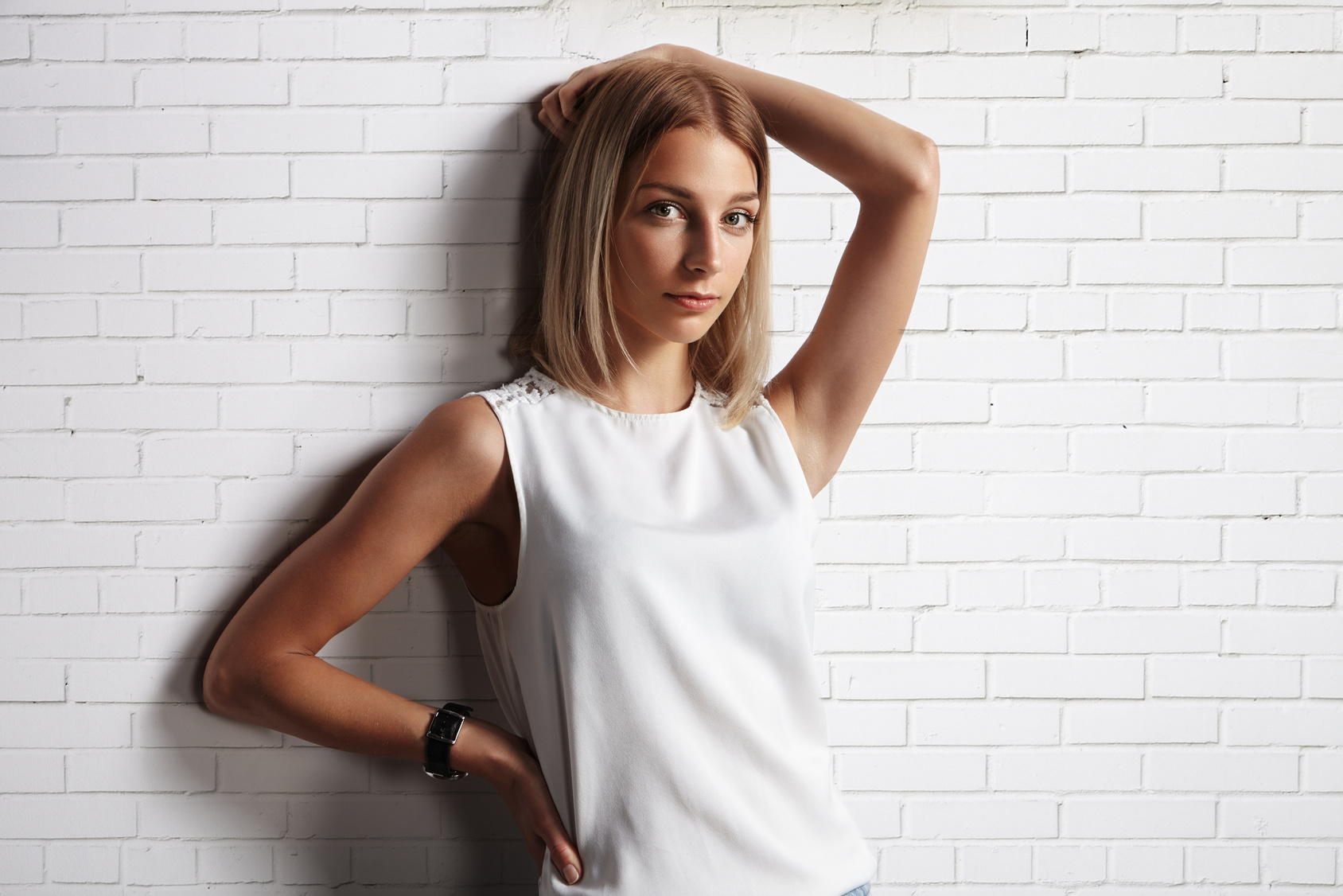 woman in a blank t-shirt. brick wall background