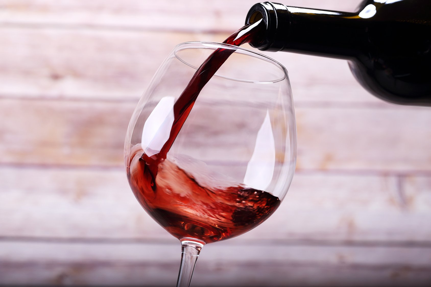 Pouring wine into glass and background
