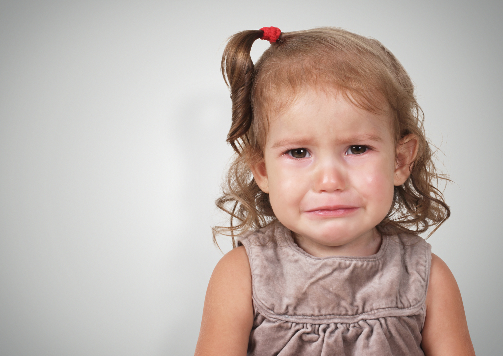 Portrait of sad crying baby girl
