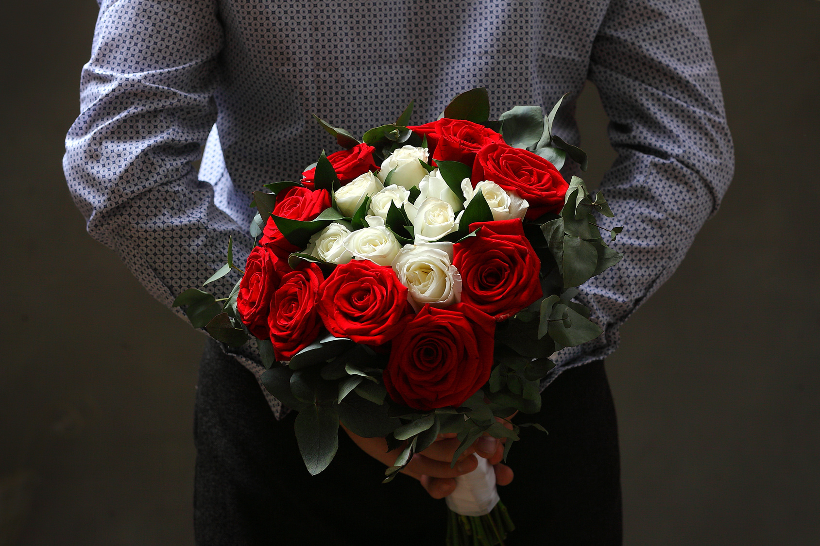 Man with flowers behind