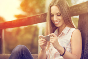 Young girl with phone outdoor
